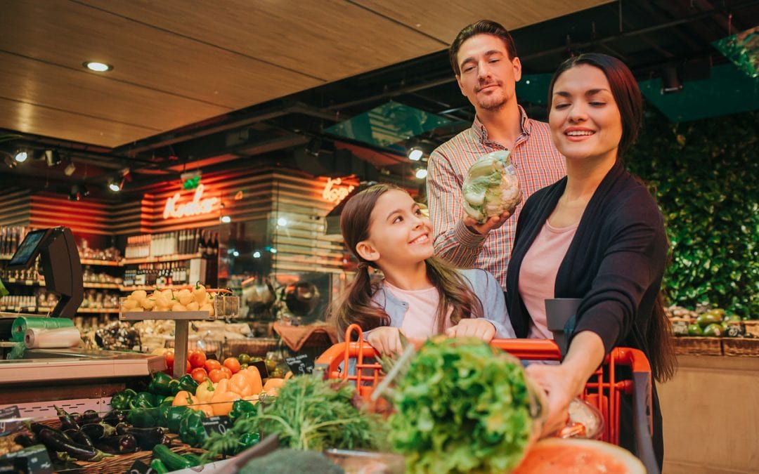 Family enjoying using their government food benefits to shop for produce.