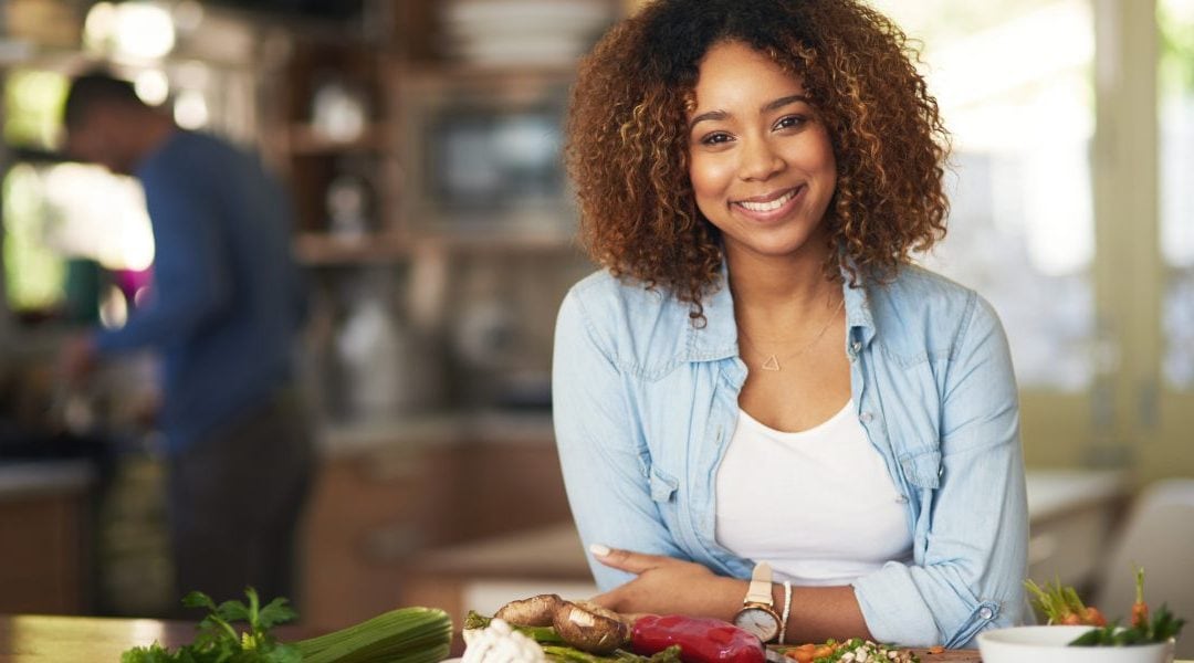 Woman smiling while enjoying her healthy meal