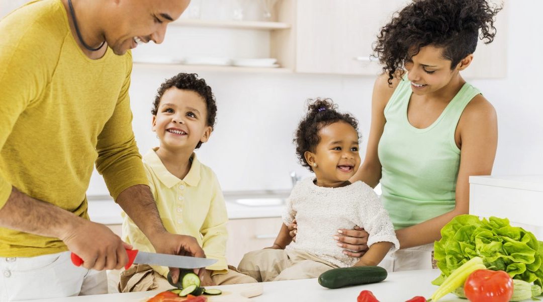 Family making healthy salads with fresh produce from their benefits