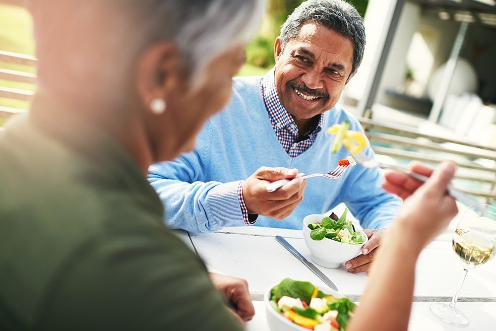 Senior couple eating a healthy salad