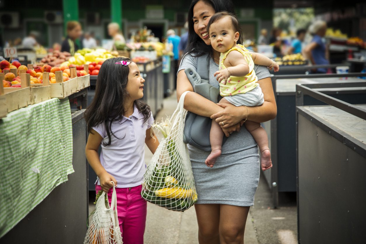Mother with kids shopping in market Mother and baby shopping with eWIC card