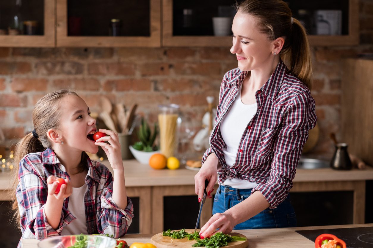happy family cook mom preparing meal home kitchen Healthy family enjoying food items purchased with their government benefits